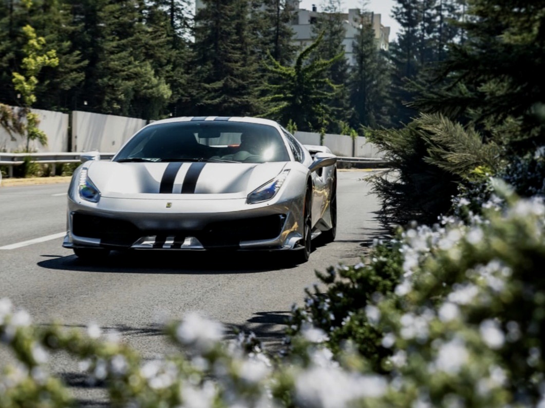 Ferrari 488 Pista, silver with black racing stripes, front three-quarter view